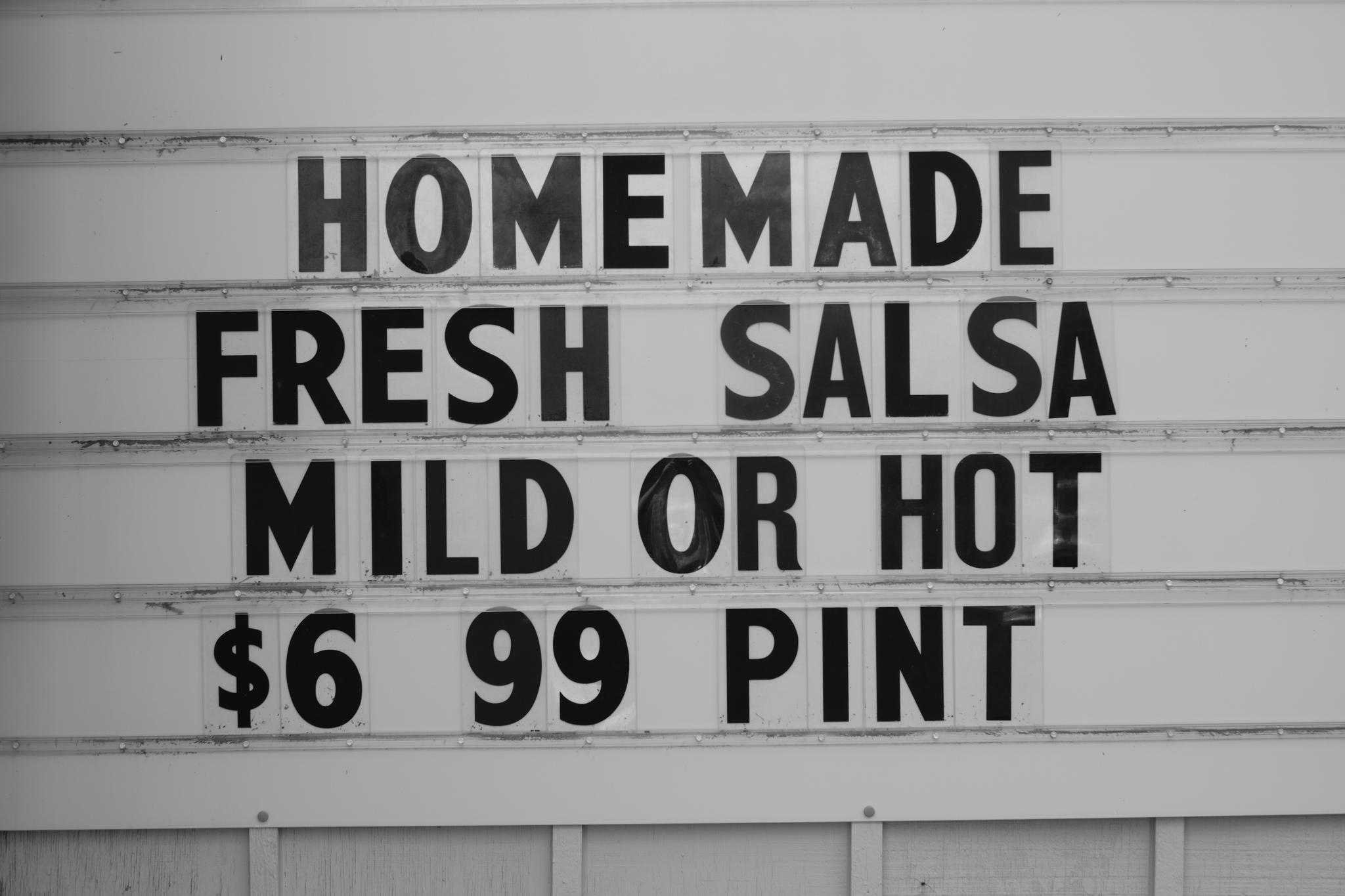 A sign advertising homemade fresh salsa, available in mild or hot, priced at $6.99 per pint