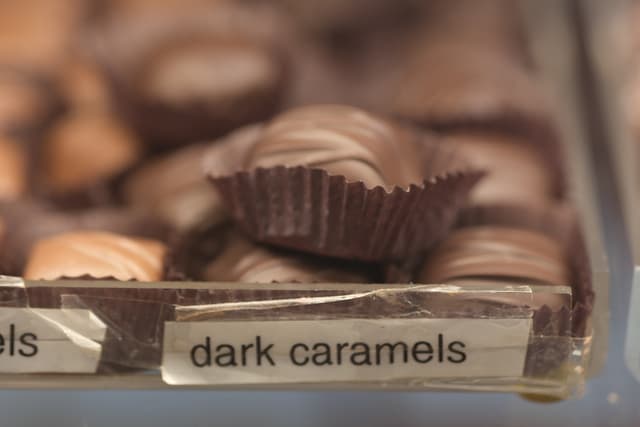Close-up of assorted chocolates in a tray with a label reading dark caramels