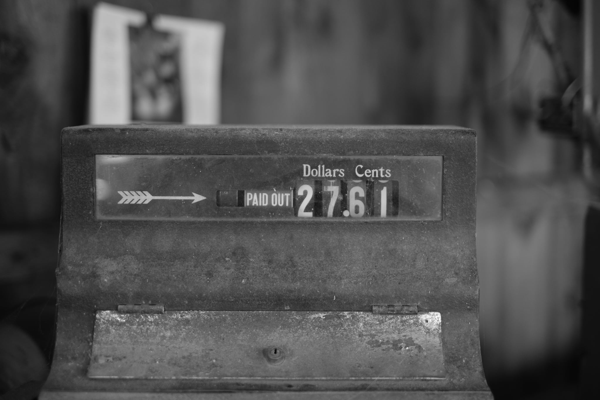 A vintage cash register displaying a total of 27 dollars and 61 cents